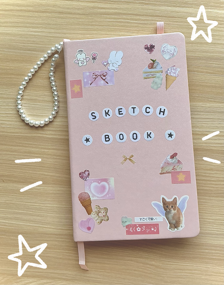 Pink sketchbook decorated with stickers